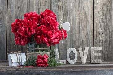 Red Flowers in a basket with a LOVE sign