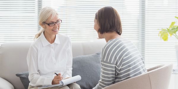 A therapist speaking to a client