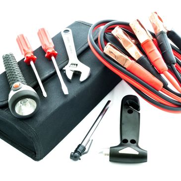 Flashlights, spanners, and screwdrivers along with red and black coloured jumper cables.