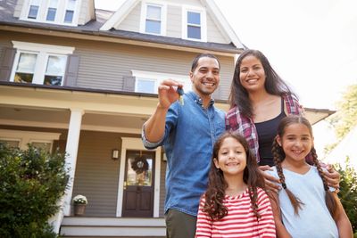 Family of buyers holding keys after buying a home