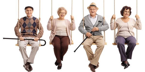 Seniors laughing on swings.
