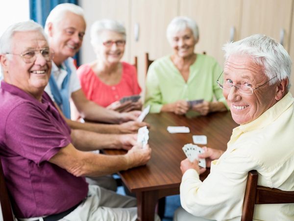 senior adults playing a game, senior adults playing cards
