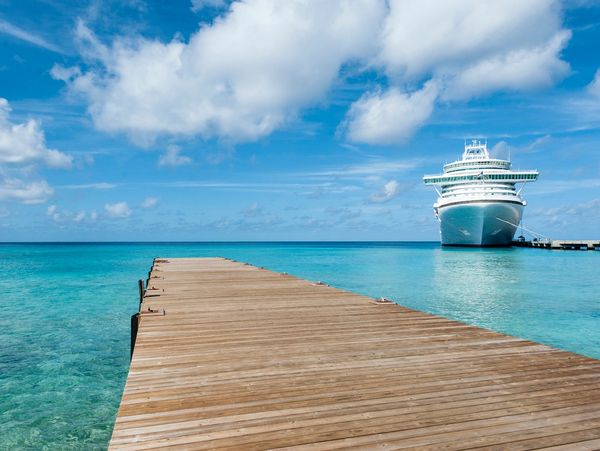 Wooden dock with a cruising ship closing in