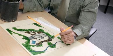 Person drawing landscaping blueprint