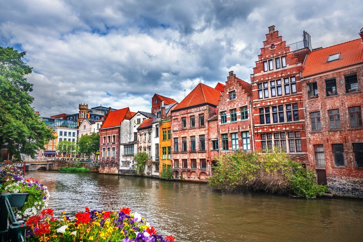 View of a serene European waterway, with charming buildings reflecting a rich architectural history.