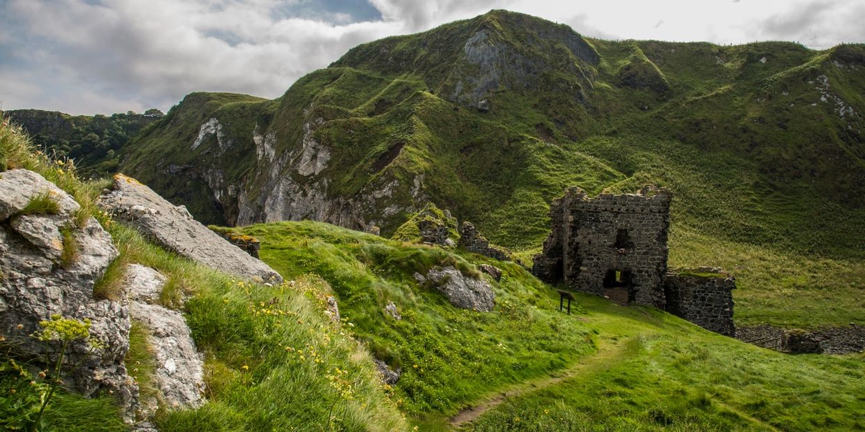 Mountains and ruins in Ireland, lush green fields