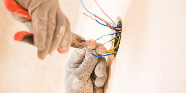 Electrical contractors crimping ends of wires