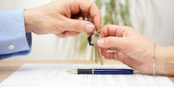 Mortgage adviser handing over keys