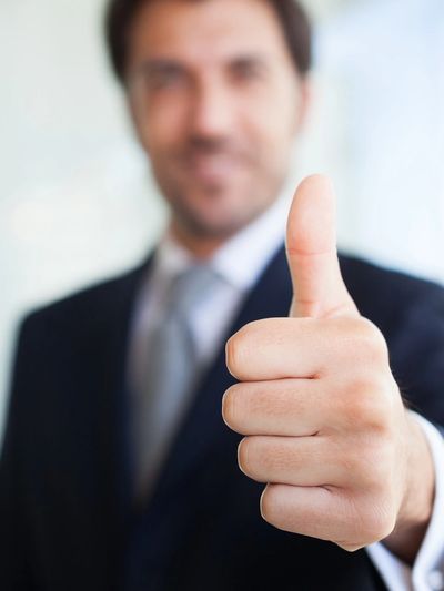 Image of a business man giving a thumbs up