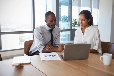 Two people discussing results in conference room