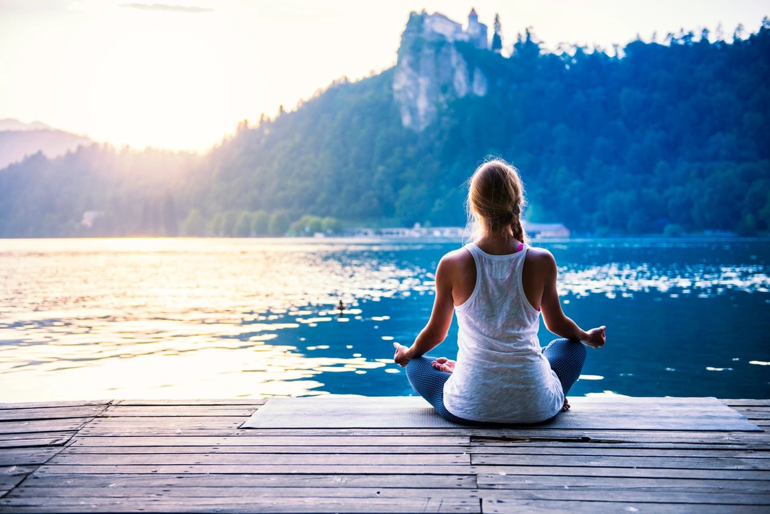 Woman meditating in nature to manage her stress