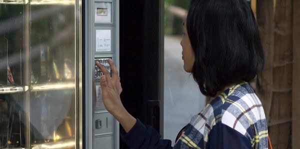 Woman buying from a vending machine
