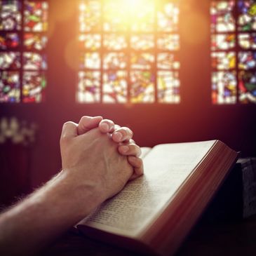 Praying hands on bible