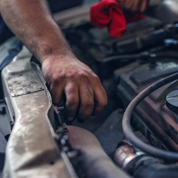 A mechanic fixing an engine.