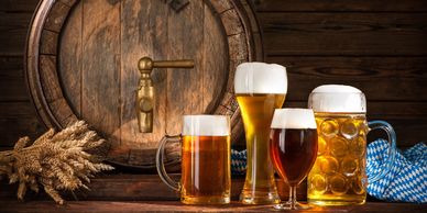 various beers in glasses with barrel and wheat