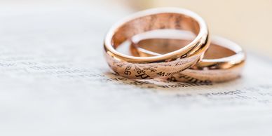 Two rings sit atop one anther, reminding us of marriage and long-term relationships needing support.