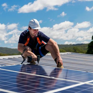 Man fixing solar panels on a roof