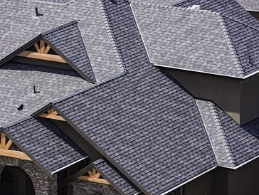 Grey shingle roof with intricate gable design on a residential house.