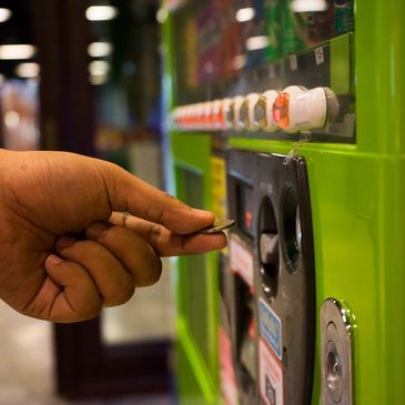 putting change into a full service vending machine