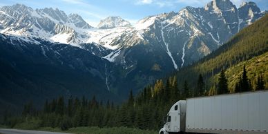Truck driving through beautiful mountain scenary