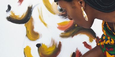 black female artist engaged in her canvas artwork