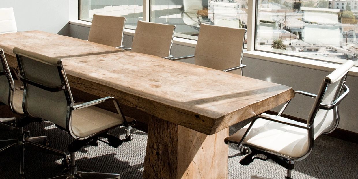 A meeting or boardroom table that is empty waiting for diverse thinkers to be recruited.