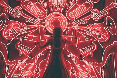 Many neon images of musical instruments emanating from a center point where the person stands.