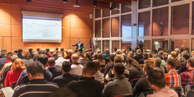 Conference attendees sitting in a presentation.