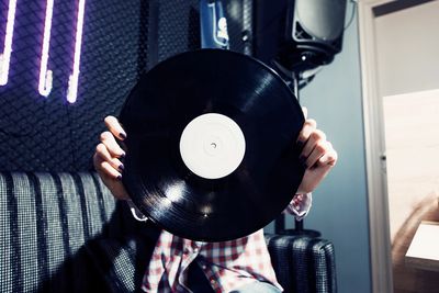 person holding a record mastering audio