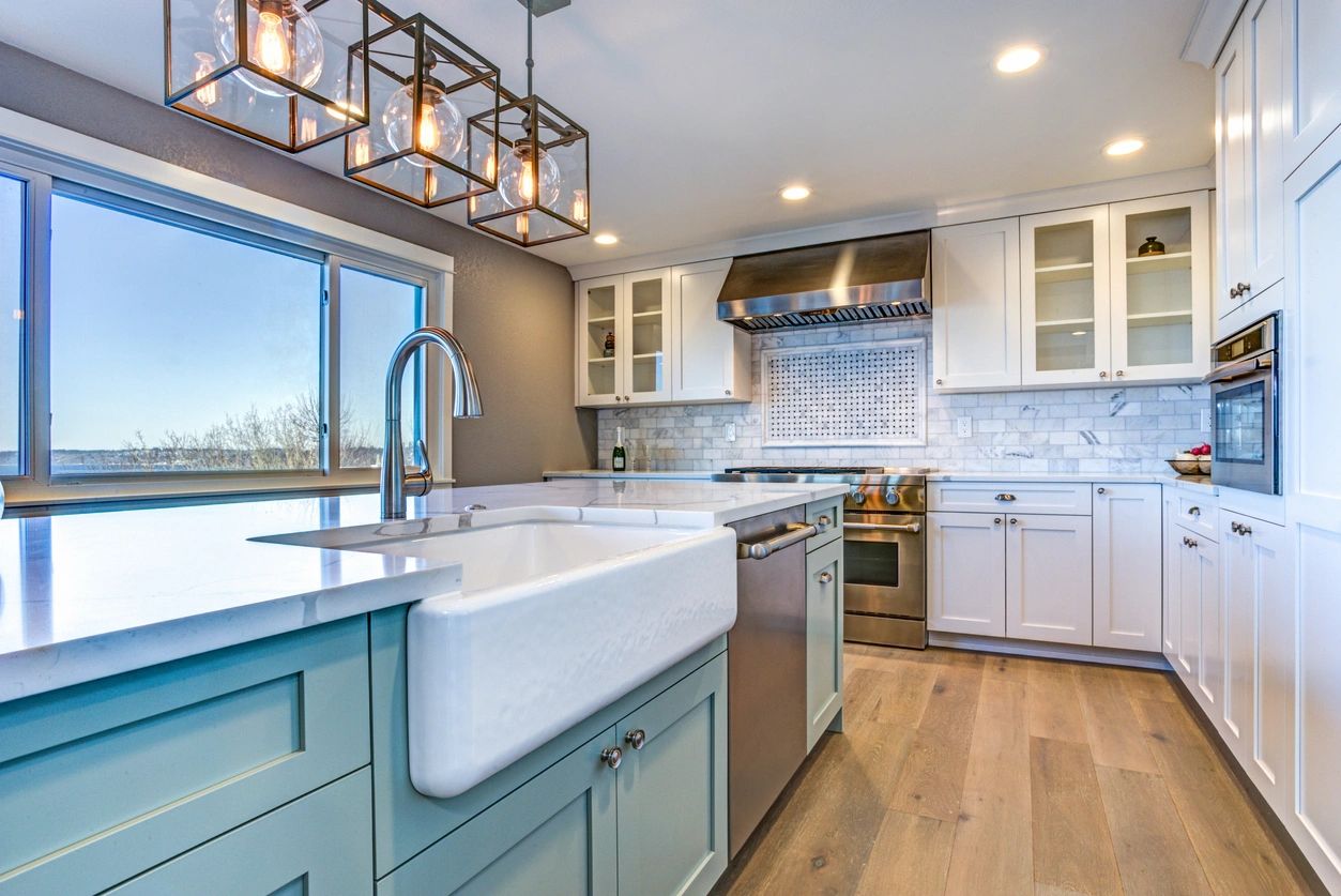 large kitchen with white cabinets, a cubed chandelier and a large window. 