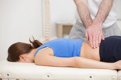 Physiotherapist treating clients lower back
