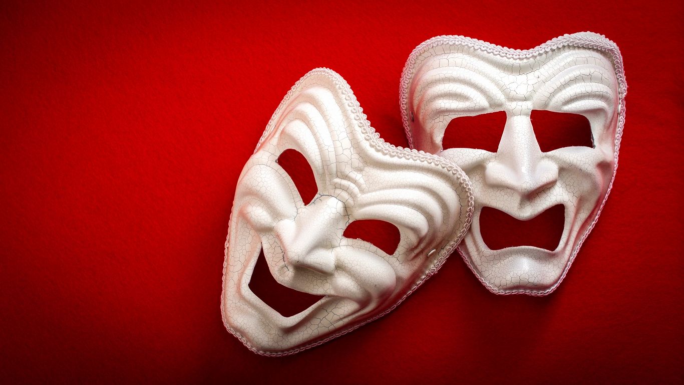 Theatre masks isolated on red background