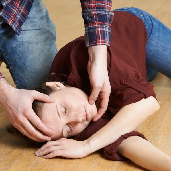 Female being placed in the recovery position.