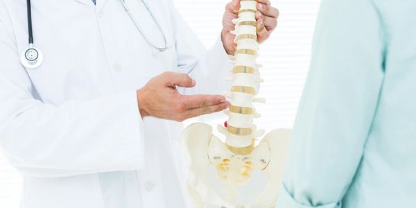 Doctor explaining spinal health to patient