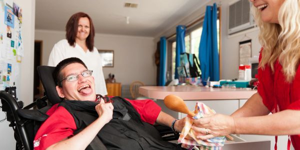 Caregiver engaging with client with disabilities 