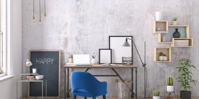 Modern workspace with a blue chair, desk, and minimalistic decor.