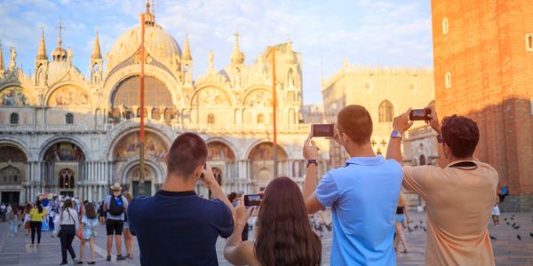 Tourists taking photos of a historic building.