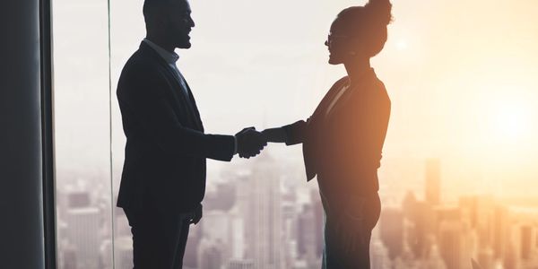 Two people shaking hands in Workplace Business Meeting