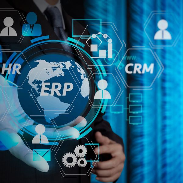 Businessman presenting digital ERP, HR, and CRM interface technology.