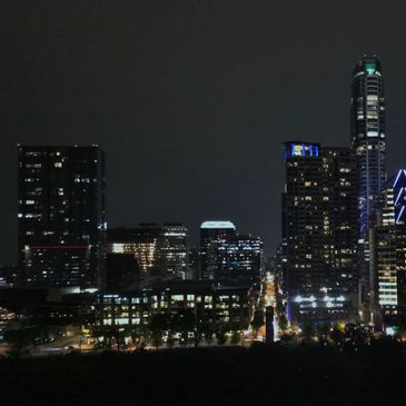 Silver Jeep SUV with American flags and dealership tag.