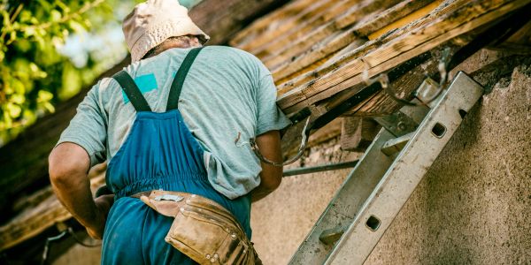 Roofing professionals working safely on a home.