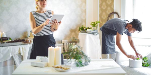 Two people preparing for an event indoors.