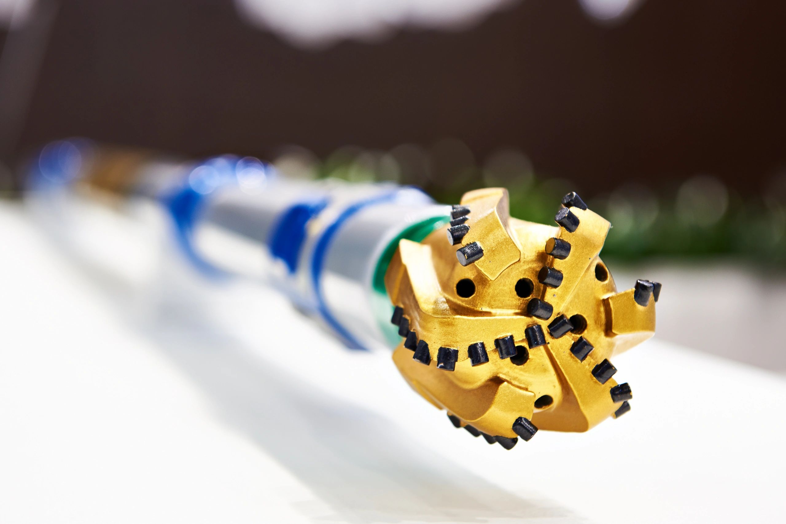 Close-up of a gold drill bit with black tips.