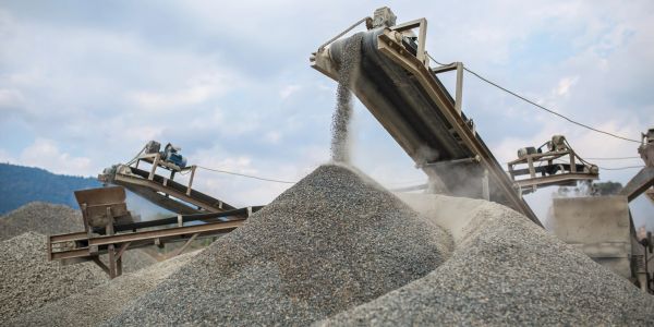 Gravel being unloaded onto a pile via conveyor belts.