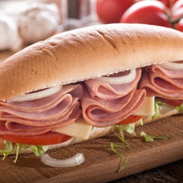 Ham and cheese sub sandwich with lettuce and tomato.