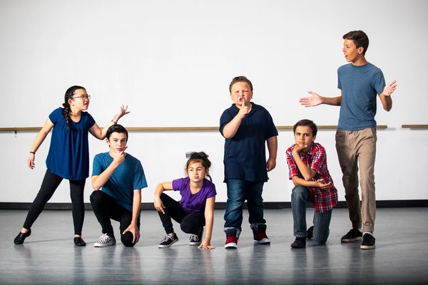 Group of kids posing in creative stances.