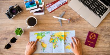 Travel planning with a map, laptop, and camera.