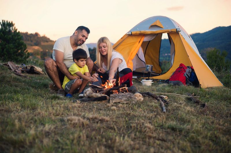 Cheerful mixed race family camping on the mountain