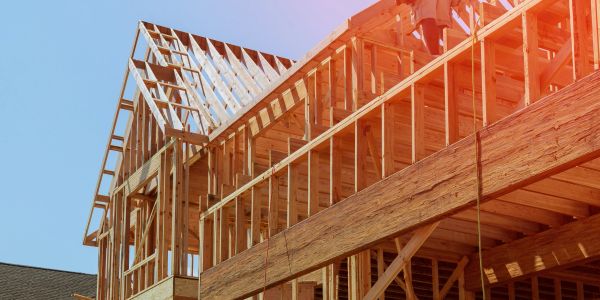 Wooden house frame under construction.