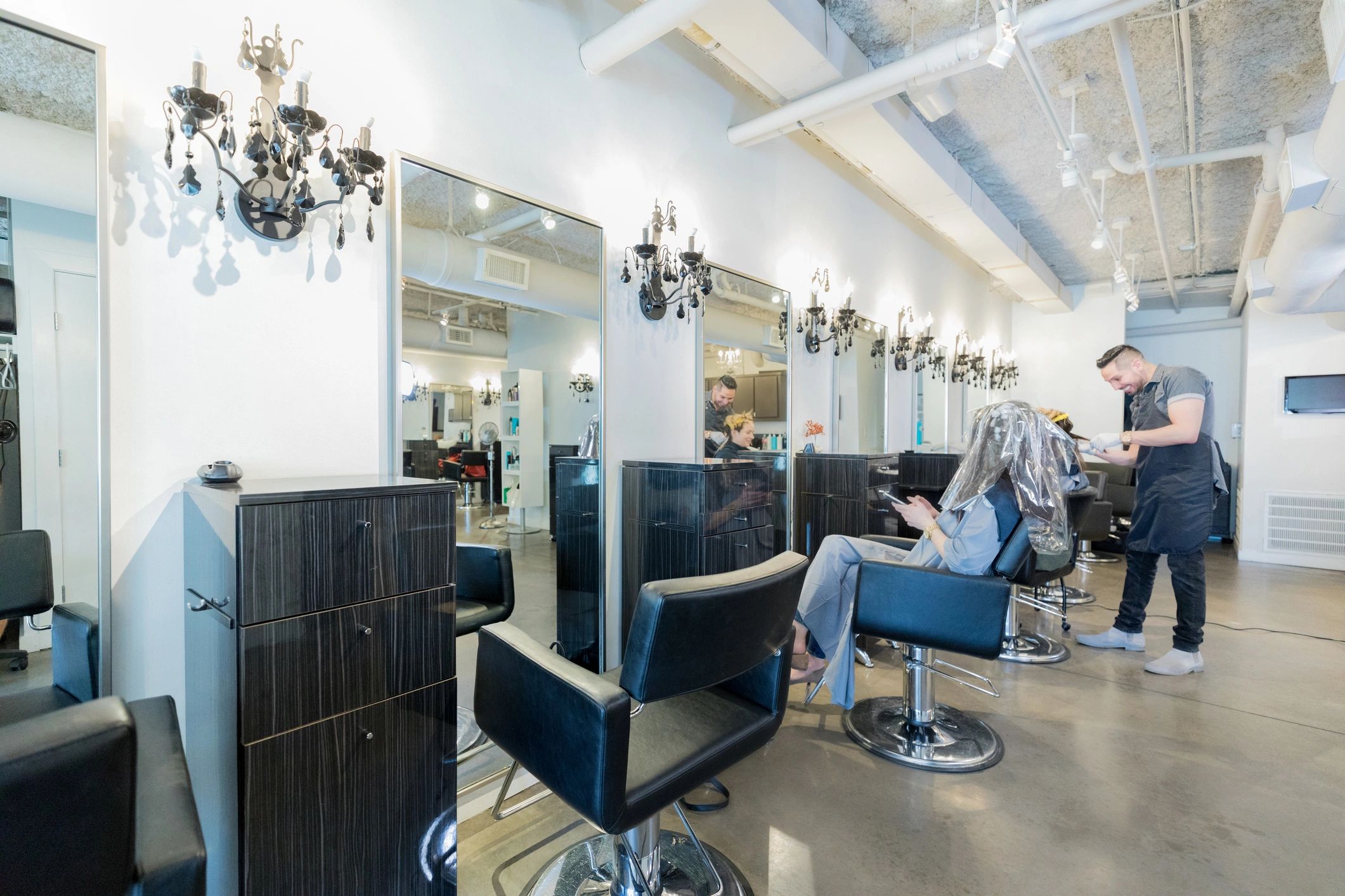 Stylists crafting elegant hair looks at Rhapsody.
